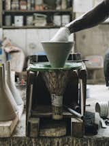 6. Release the Pendant: Mamadou removes the pendant, using a special clamp and tapping the edges of the form with a hammer to help release the cast. It is then left to set for 7 to 12 days,  depending on temperature and humidity.