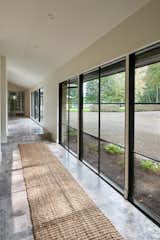 A long, windowed walkway creates a strong indoor/outdoor connection.