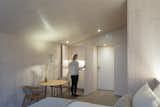 The walls, floors, and ceilings in the studio units feature pale wood finishes.