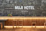 The material palette for the hotel is simple and natural, showcasing wood, stone, and soil.