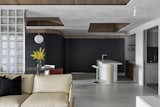 A curving charcoal wall covered in chalkboard paint lines one side of the open living area.