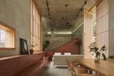 A Ribbon of Red Seating Ties Together a Sublime Concrete Home in India