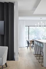 Felted louvres between the entrance and the living room provide acoustic insulation and warmth while still allowing light to penetrate the interior.