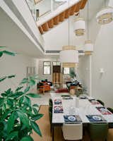 Scene Shang designed the dining room’s pendants. "They have very simple, geometric shapes inspired by Chinese lanterns, and the black-and-white palette, while influenced by traditional Chinese design, is simplified, a bit more free in shape and localized with rattan," says co-founder and designer Jessica Wong. 