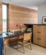 The custom white oak-and-steel desk and cabinets are by Filtch, topped with a charcoal-finished white oak slab. Matching Fenton and Fenton desk chairs offer the homeowners the opportunity to work side by side.